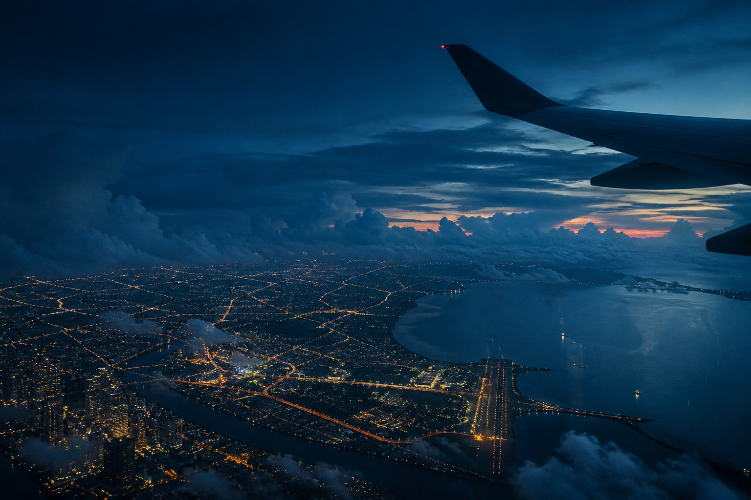 Airplane wing above Kuala Lumpur at blue hour